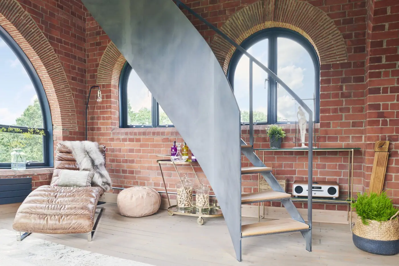 Exposed brickwork and sculptural steel stair installation